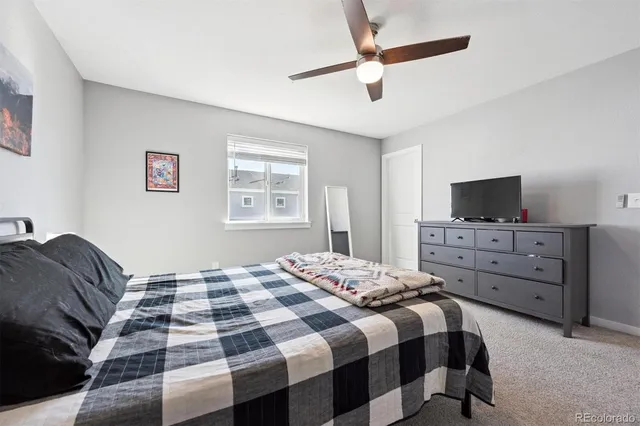 a bedroom with a bed and flat screen tv