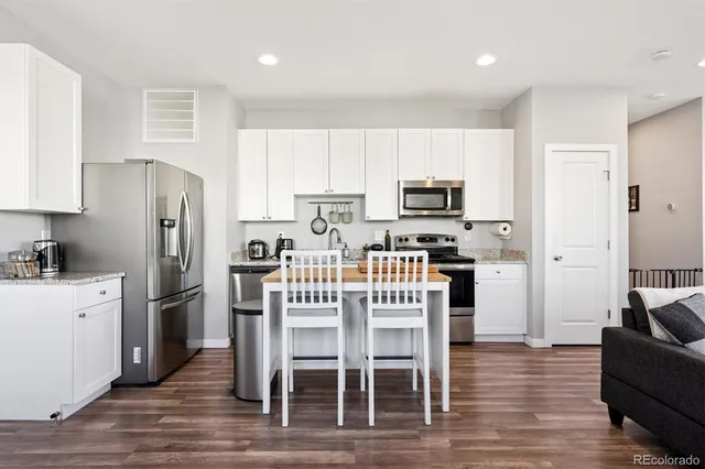 a kitchen with stainless steel appliances a refrigerator stove microwave and cabinets