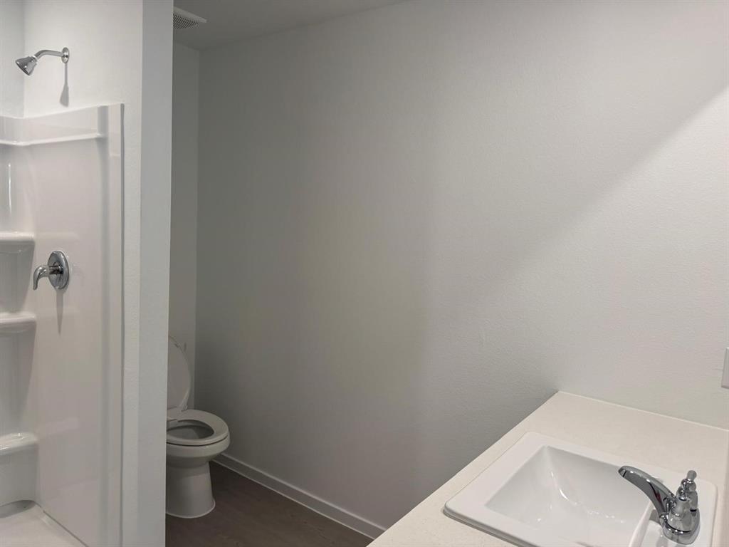 7505 Fenton Parkway Pilot Point, TX 76258 - Photo 16 of 30 a bathroom with a toilet and a sink