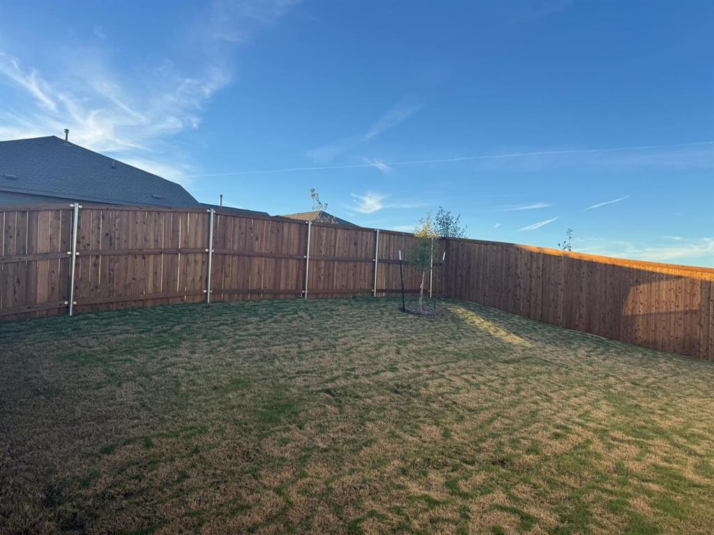 7505 Fenton Parkway Pilot Point, TX 76258 - Photo 27 of 30 a view of a backyard with wooden fence