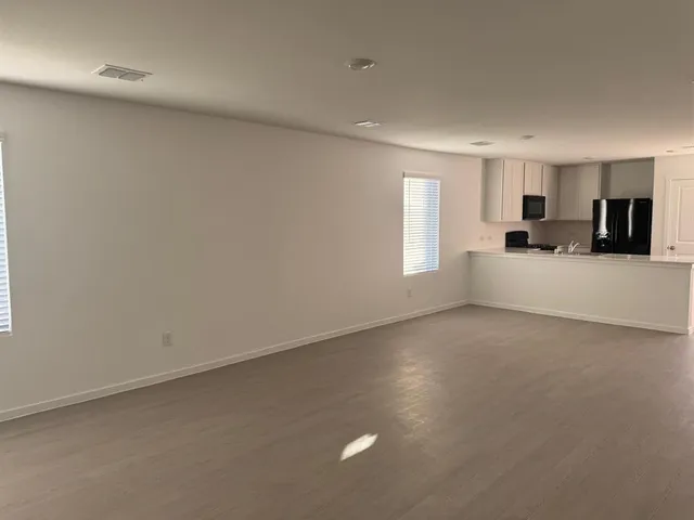 a view of kitchen with kitchen island microwave and sink