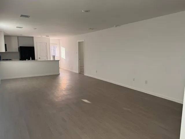 a kitchen with a refrigerator and a stove top oven