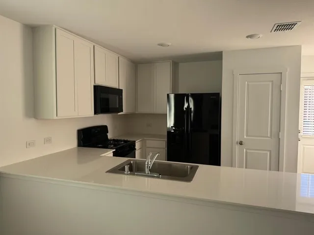 a kitchen with cabinets and appliances