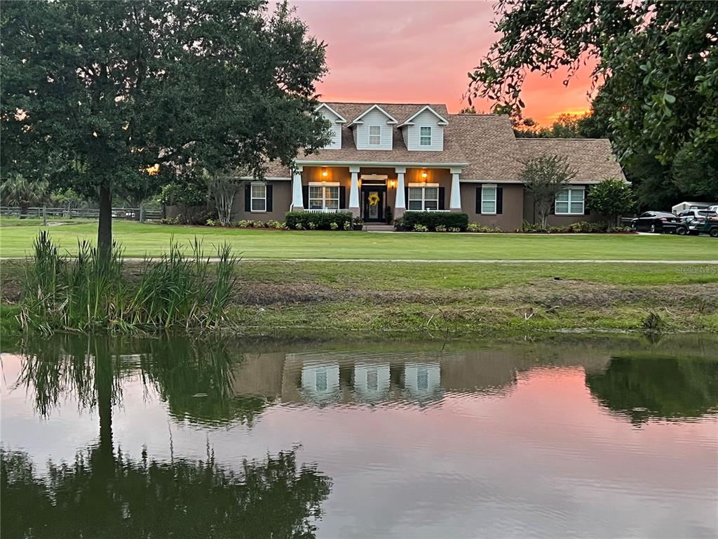 3065 Cork Road Plant City, FL 33565 - Photo 1 of 1 a front view of a house with a lake view