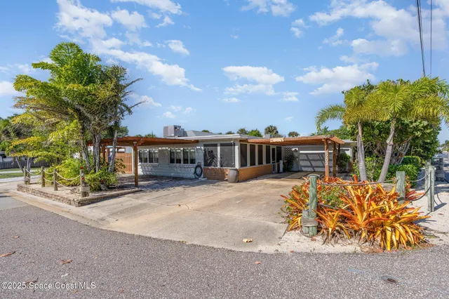 a front view of house with a garden