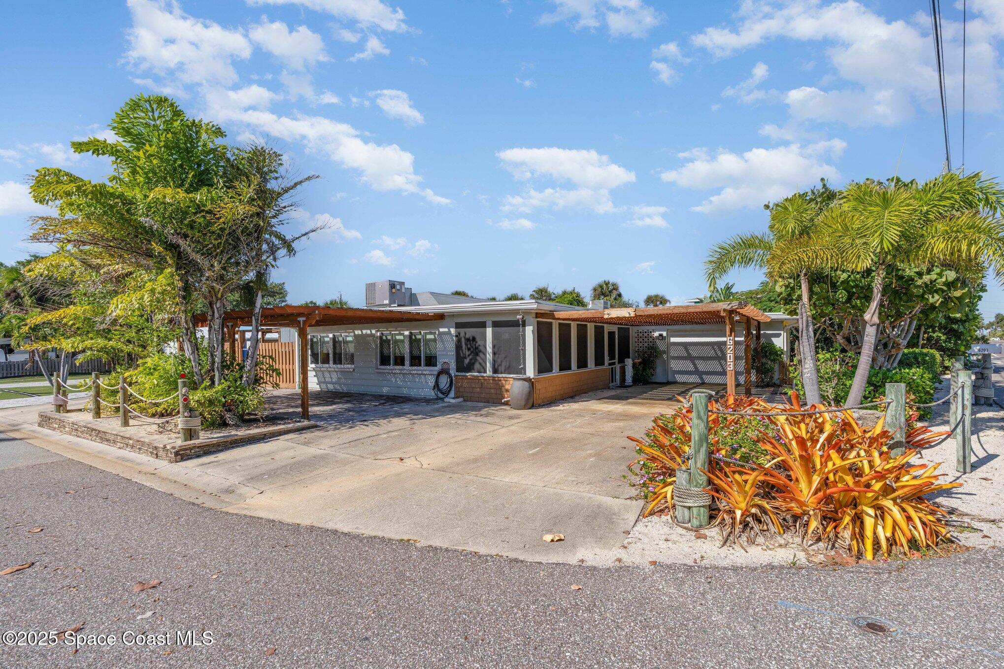 a front view of house with a garden