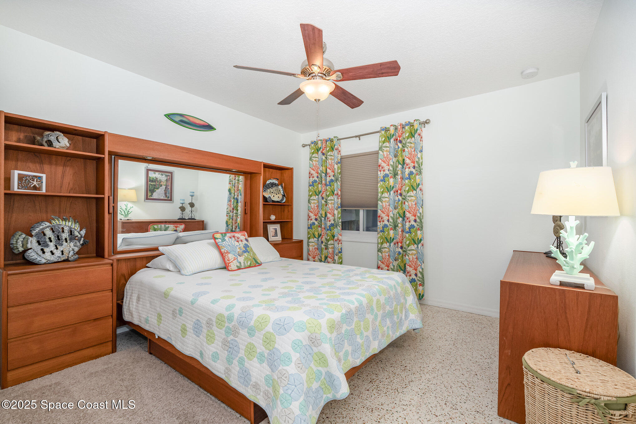6203 Ridgewood Avenue Cocoa Beach, FL 32931 - Photo 13 of 37 a bedroom with a bed and a chandelier