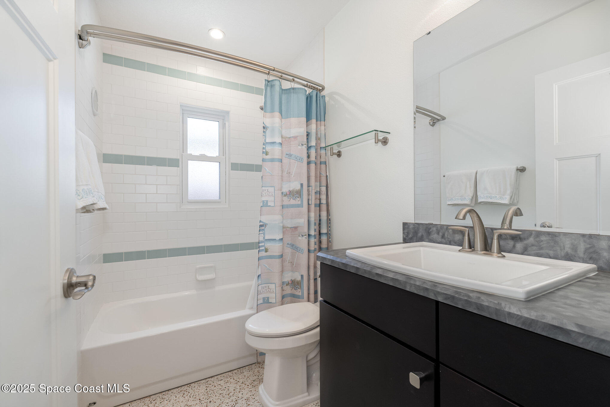 6203 Ridgewood Avenue Cocoa Beach, FL 32931 - Photo 14 of 37 a bathroom with a granite countertop sink toilet and shower
