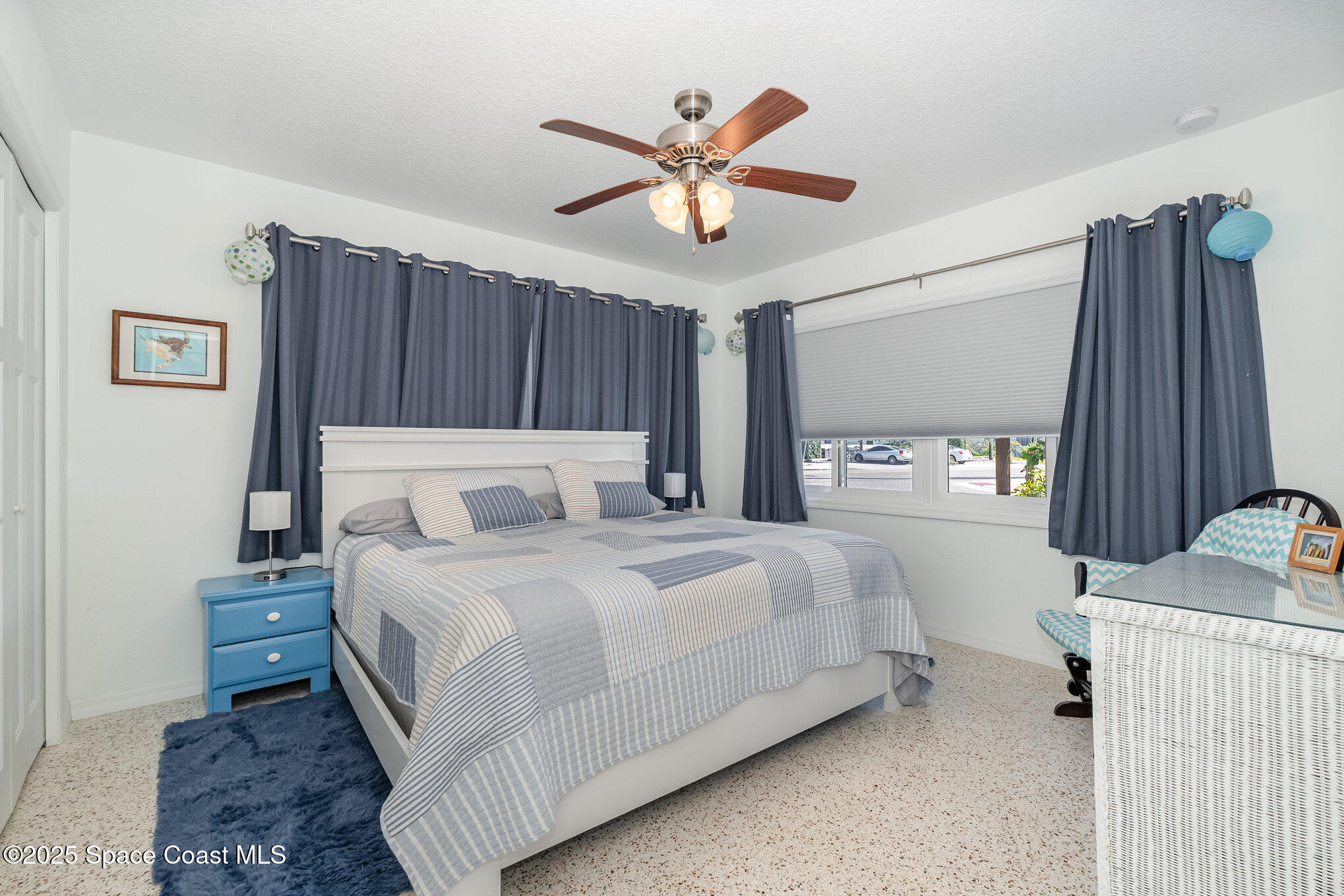 6203 Ridgewood Avenue Cocoa Beach, FL 32931 - Photo 15 of 37 a bedroom with a bed and a chandelier