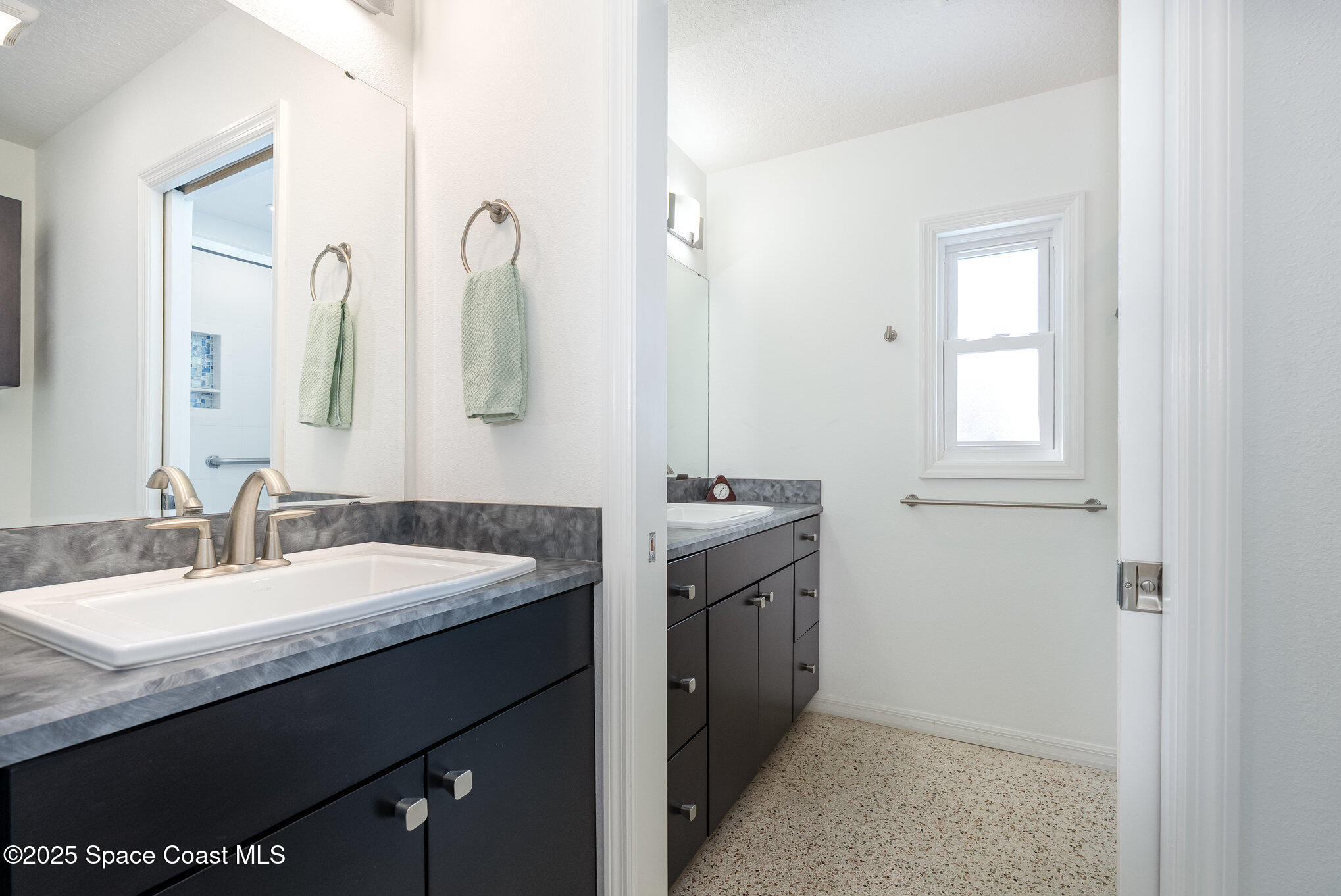 6203 Ridgewood Avenue Cocoa Beach, FL 32931 - Photo 16 of 37 a bathroom with a granite countertop sink and a mirror