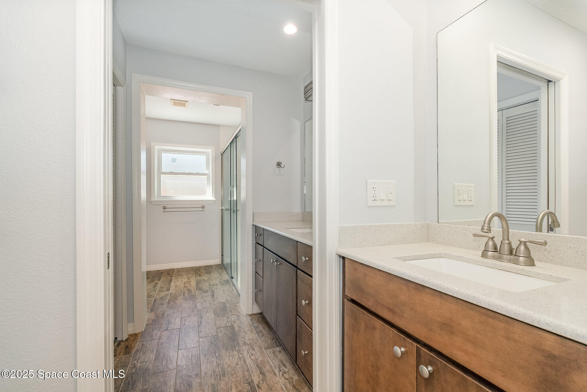 6203 Ridgewood Avenue Cocoa Beach, FL 32931 - Photo 20 of 37 a spacious bathroom with a sink and a mirror