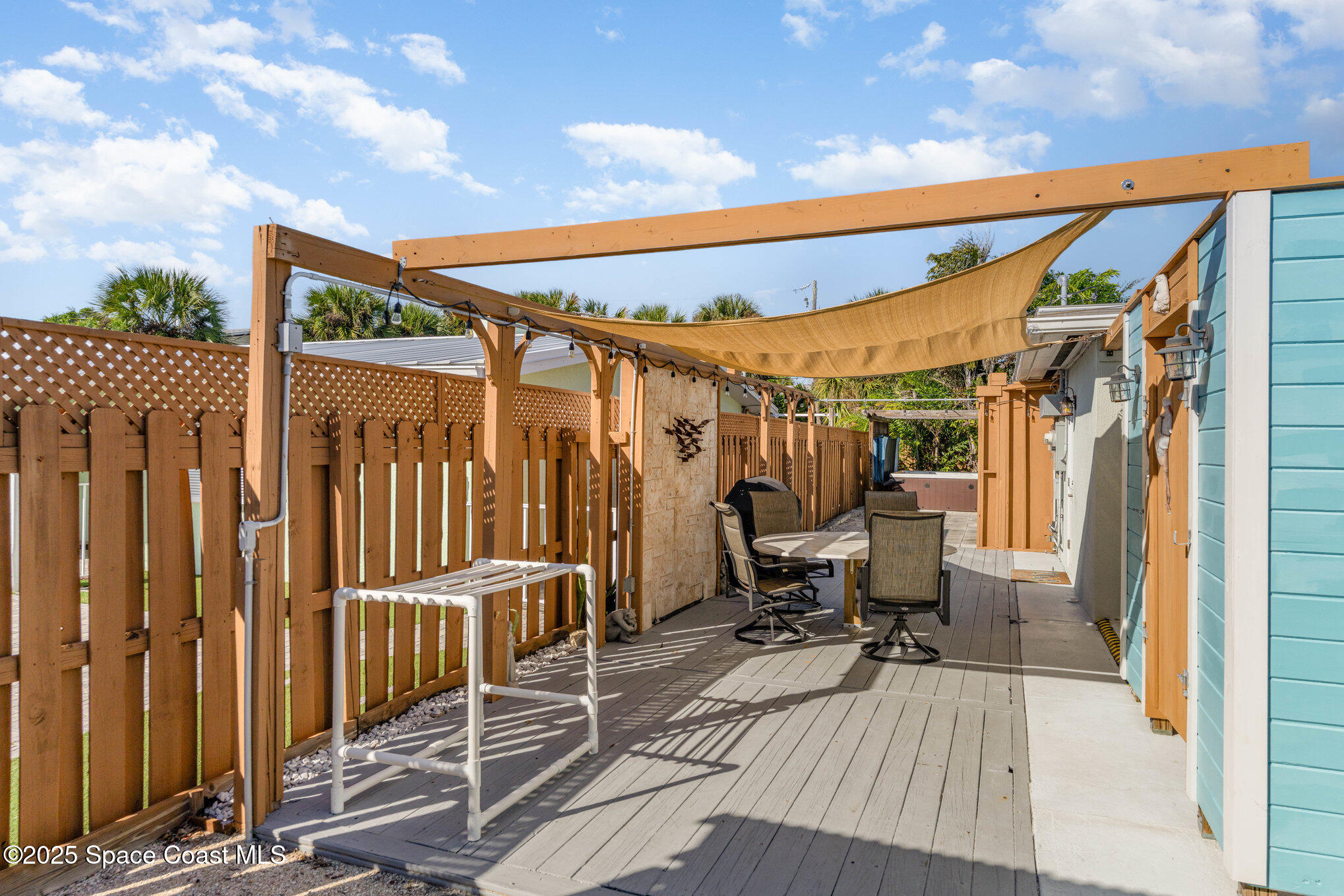 6203 Ridgewood Avenue Cocoa Beach, FL 32931 - Photo 27 of 37 a view of a patio with a table and chairs