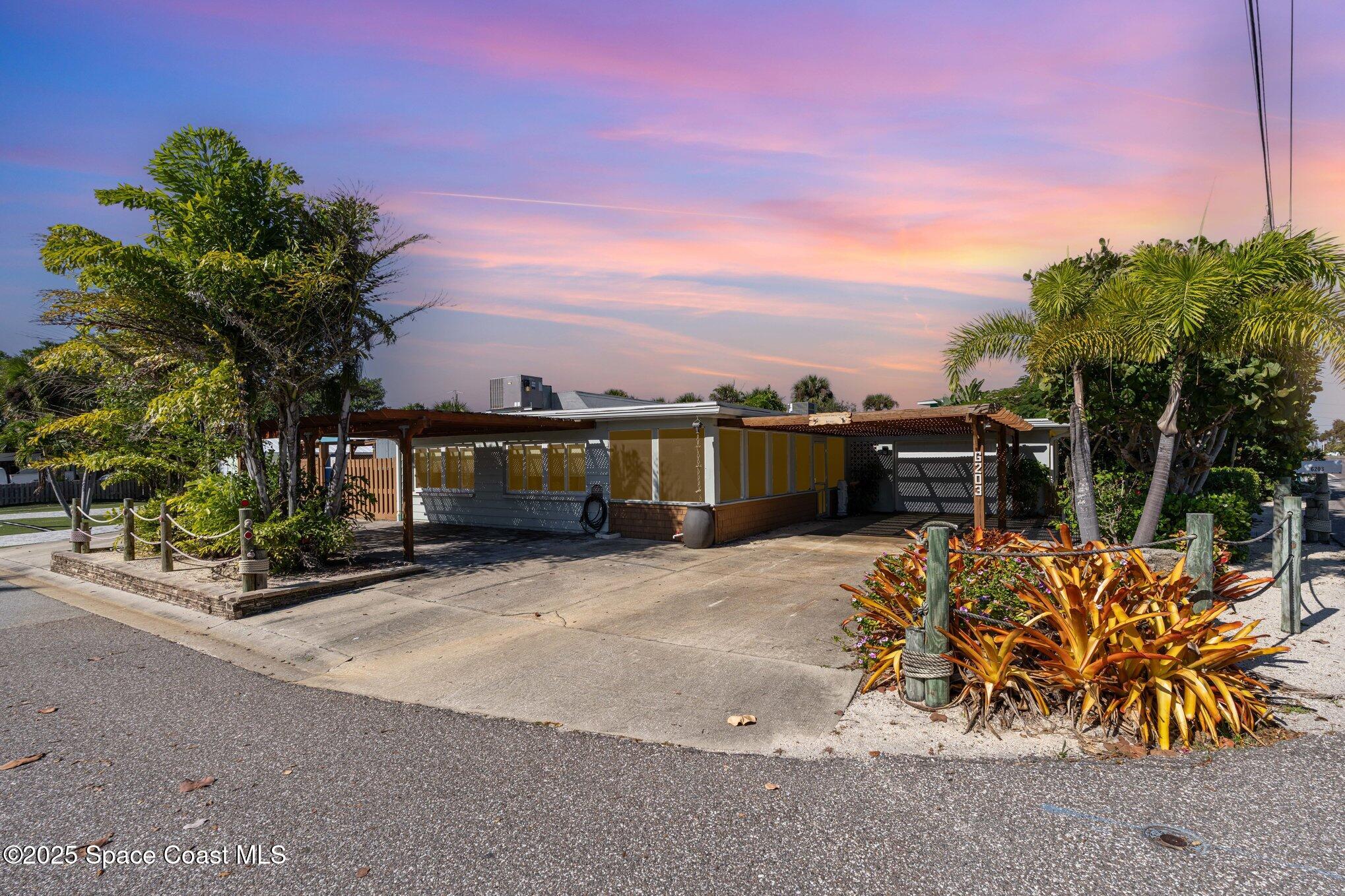 6203 Ridgewood Avenue Cocoa Beach, FL 32931 - Photo 31 of 37 a front view of a house with a yard