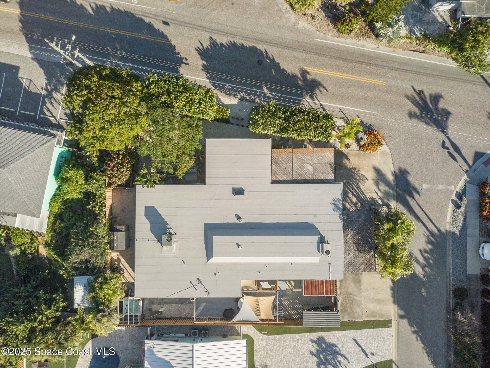 6203 Ridgewood Avenue Cocoa Beach, FL 32931 - Photo 32 of 37 an aerial view of a house with a yard