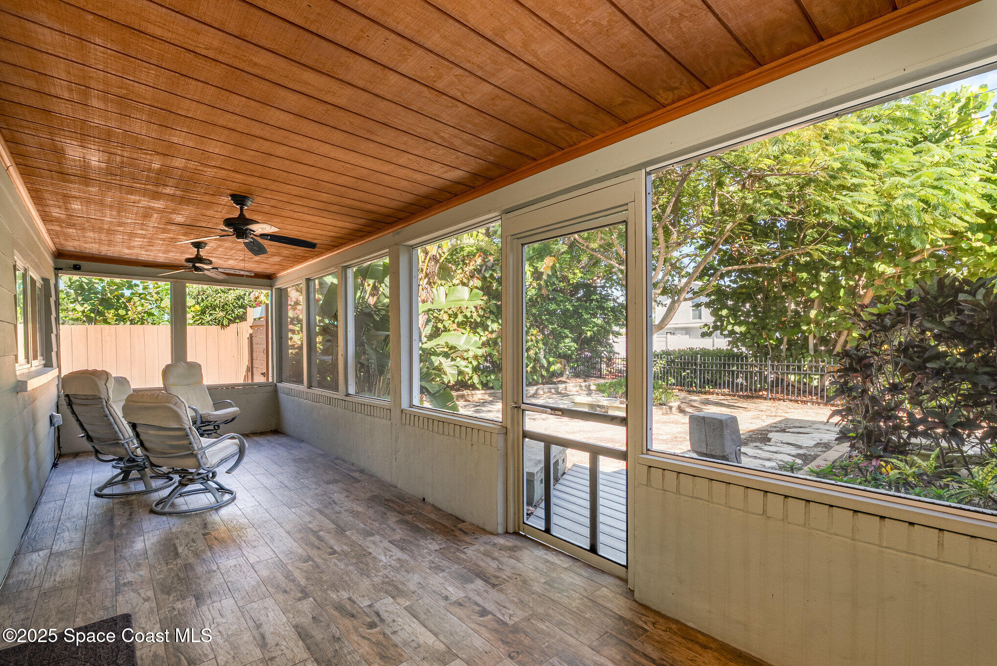 6203 Ridgewood Avenue Cocoa Beach, FL 32931 - Photo 5 of 37 a living room with furniture and floor to ceiling windows
