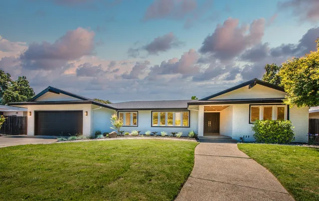 a front view of house with yard and green space