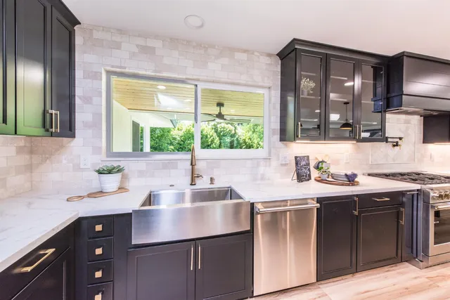 a kitchen with a sink stove and cabinets