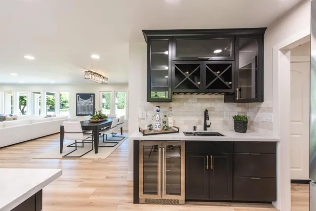a kitchen with a sink cabinets and wooden floor