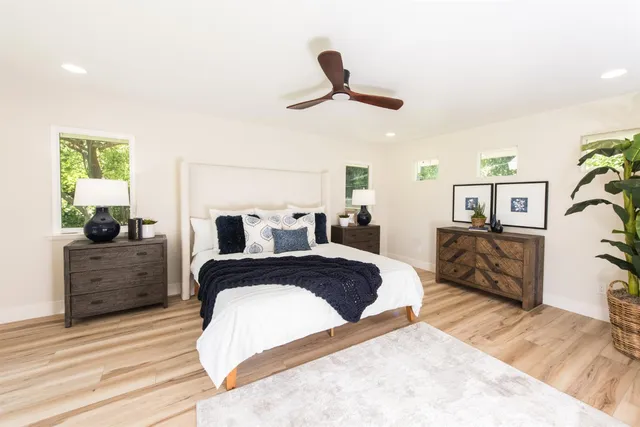 a bedroom with a bed and wooden floor