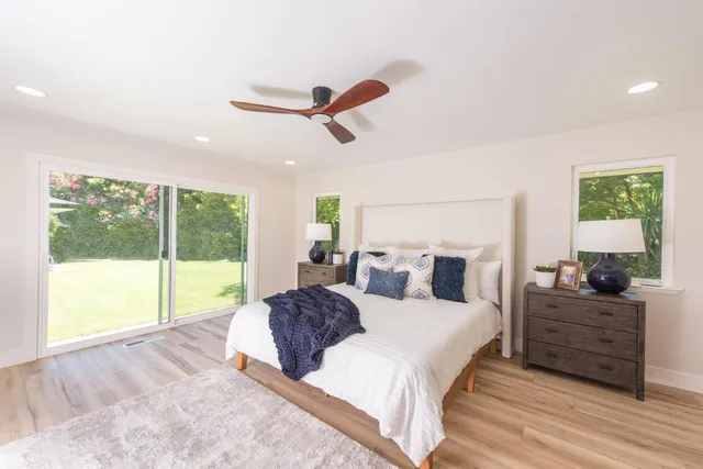 a bedroom with a large bed and a large window