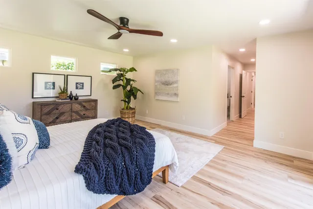 a spacious bedroom with a bed and a chandelier
