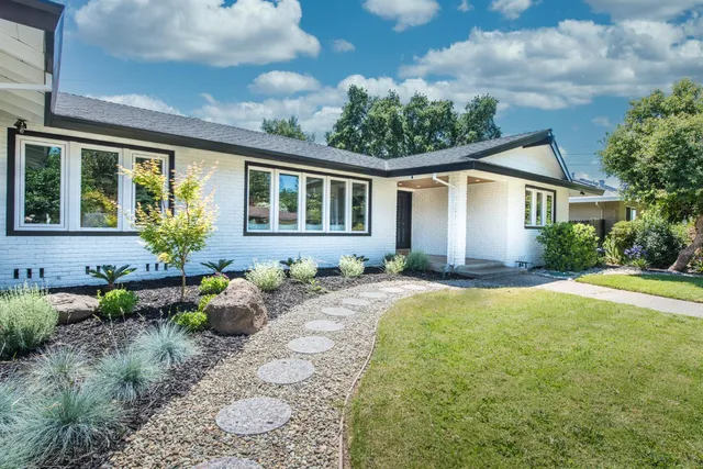 a front view of a house with garden