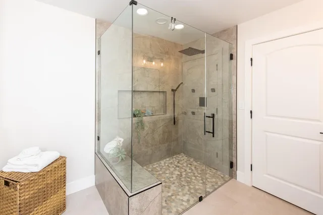 a bathroom with a glass shower door and a bathtub