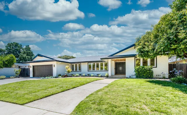 a front view of house with yard and green space