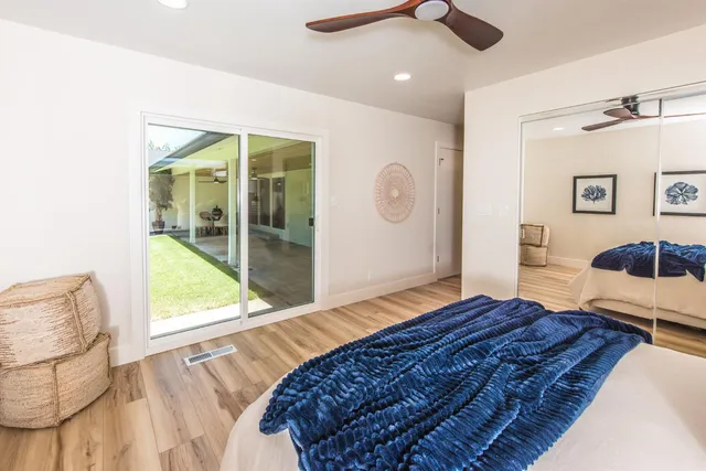 a living room with a bed furniture and a large window