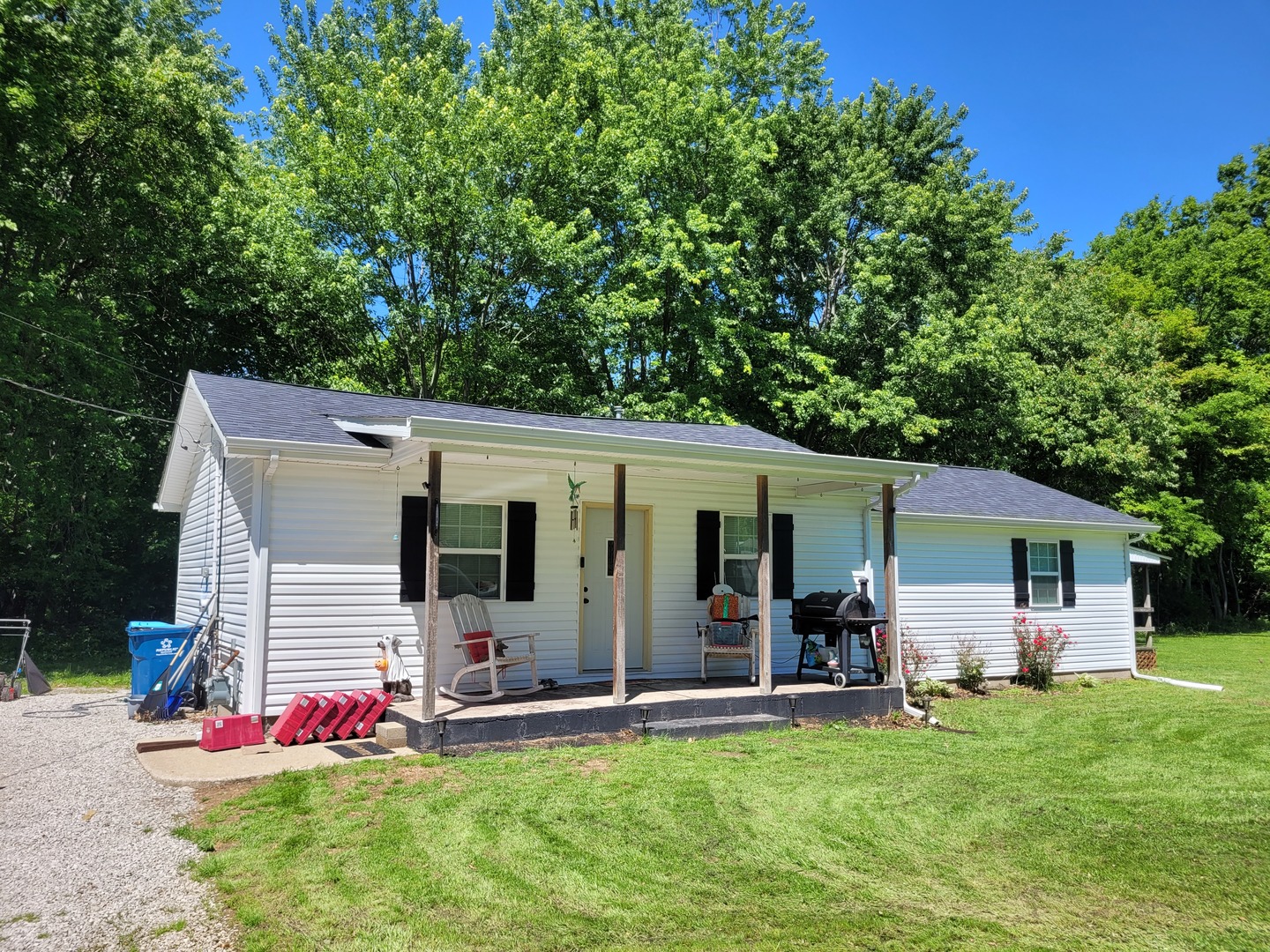a view of a house with backyard and porch