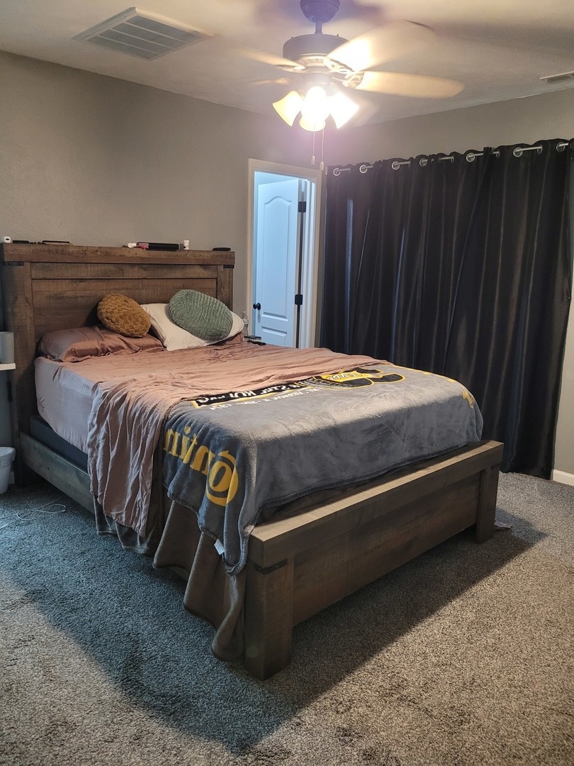 1102 East Bethel Road Mount Vernon, IL 62864 - Photo 13 of 16 a spacious bedroom with a bed and a chandelier