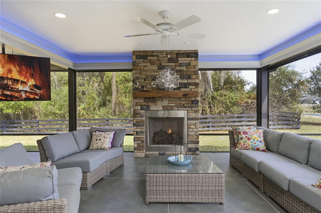 4788 Rostas Way The Villages, FL 32163 - Photo 13 of 40 a living room with furniture a fireplace and a large window