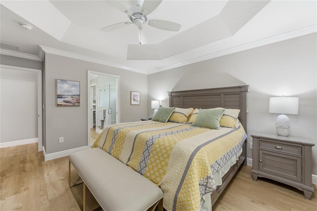 4788 Rostas Way The Villages, FL 32163 - Photo 19 of 40 a bedroom with a bed and a chandelier