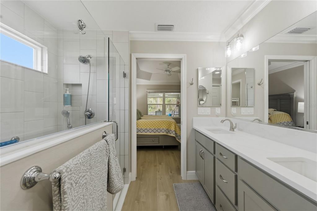 4788 Rostas Way The Villages, FL 32163 - Photo 21 of 40 a en suite bathroom with a granite countertop tub shower double vanity and a mirror