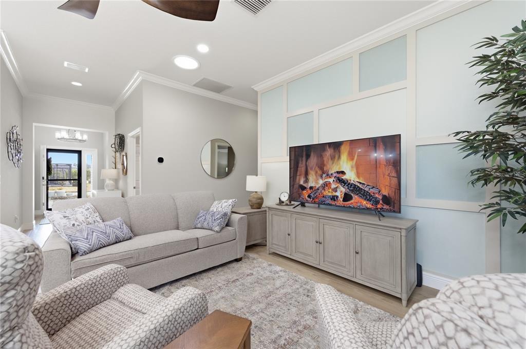 4788 Rostas Way The Villages, FL 32163 - Photo 4 of 40 a living room with furniture and a flat screen tv