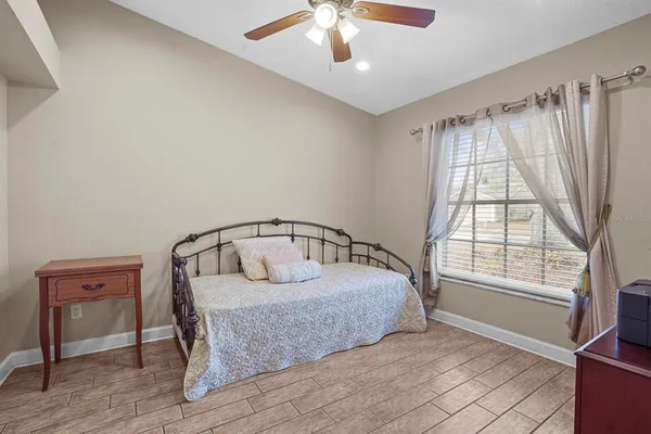 a bedroom with a bed and a large window