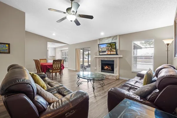 a living room with furniture ceiling fan and a fireplace