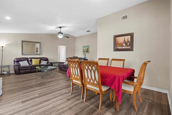 a view of a a dining room with furniture window and wooden floor
