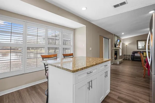 a kitchen with counter top space and wooden floor