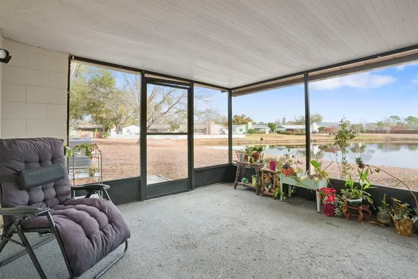 a living room with furniture and floor to ceiling windows
