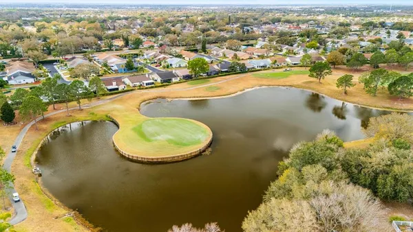 an aerial view of a swimming pool with outdoor seating