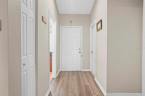 a view of a hallway with wooden floor