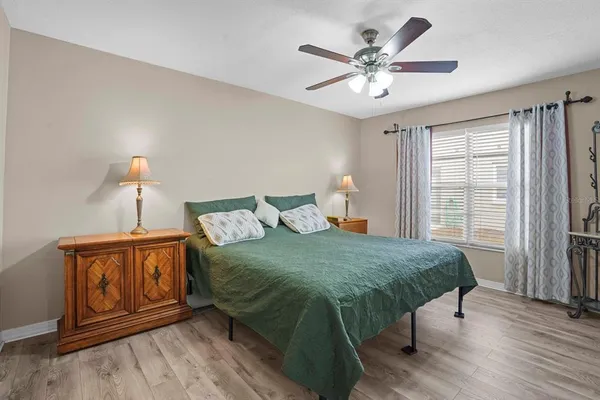 a bedroom with a bed window and a ceiling fan
