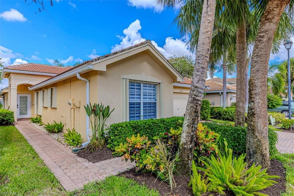 1630 Triangle Palm Terrace Naples, FL 34119 - Photo 19 of 24 a view of a house with a yard and plants