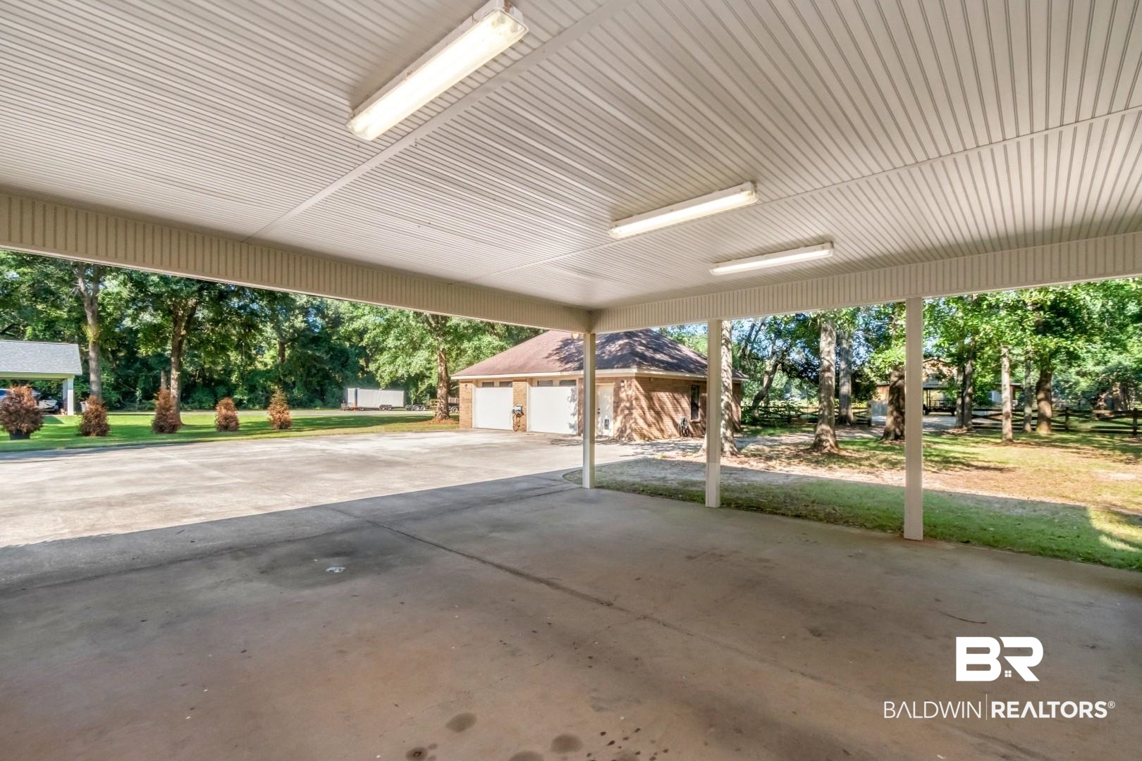 1360 Dykes Road North Mobile, AL 36608 - Photo 26 of 40 View of patio / terrace with an outdoor structure and a garage
