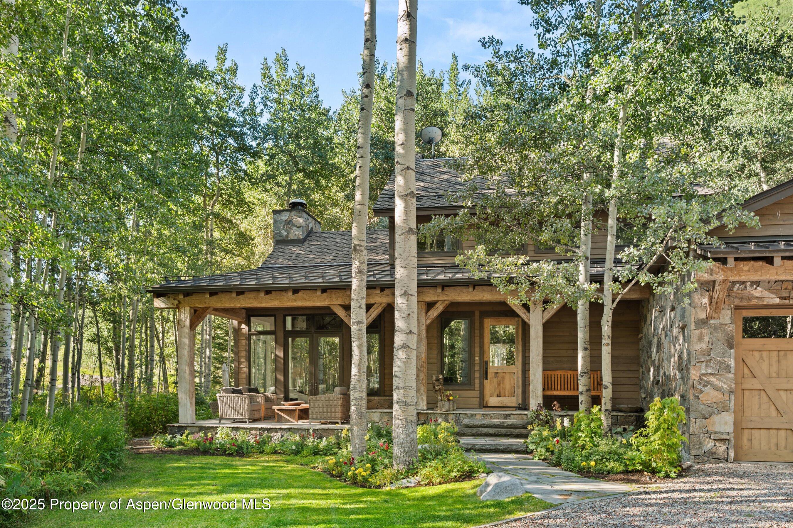 9555 Castle Creek Road Aspen, CO 81612 - Photo 2 of 42 front view of a house with a yard