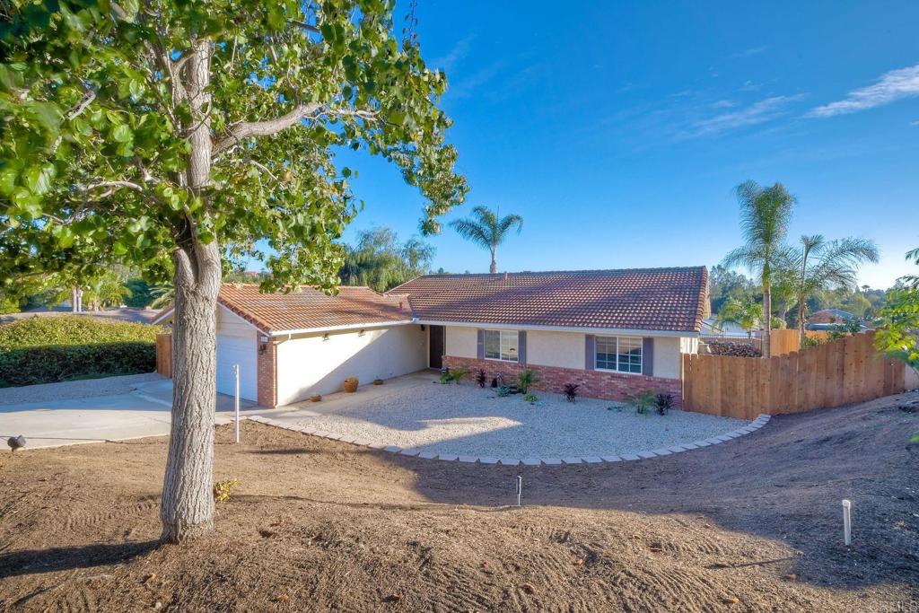 a view of a house with a tree in the background