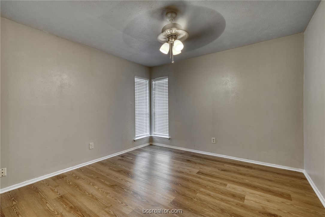 2400 Toro Lane, Unit A Bryan, TX 77807 - Photo 2 of 8 a view of an empty room with wooden floor and a window