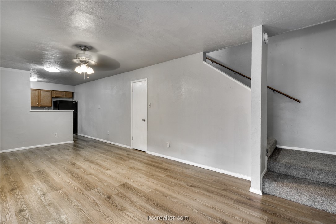 2400 Toro Lane, Unit A Bryan, TX 77807 - Photo 8 of 8 an empty room with wooden floor and ceiling fan