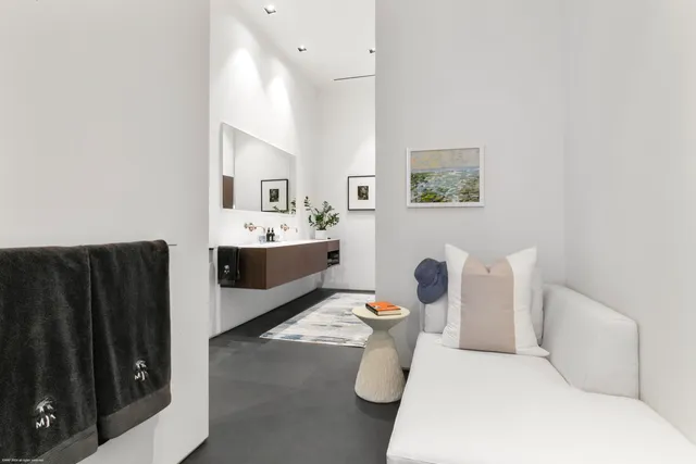 a bathroom with a bathtub sink and mirror